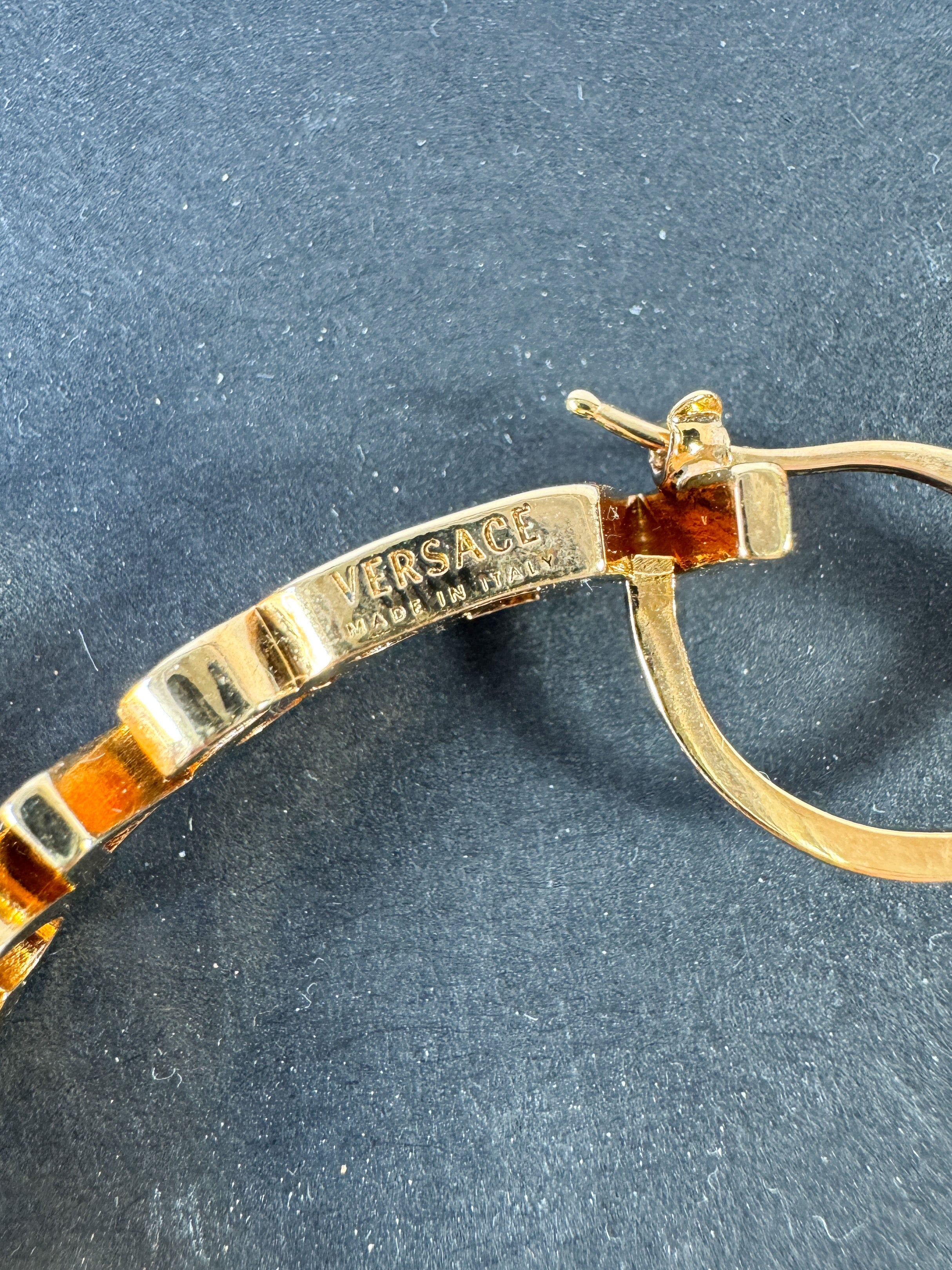 Versace logo gold tone hoop earrings retail $650