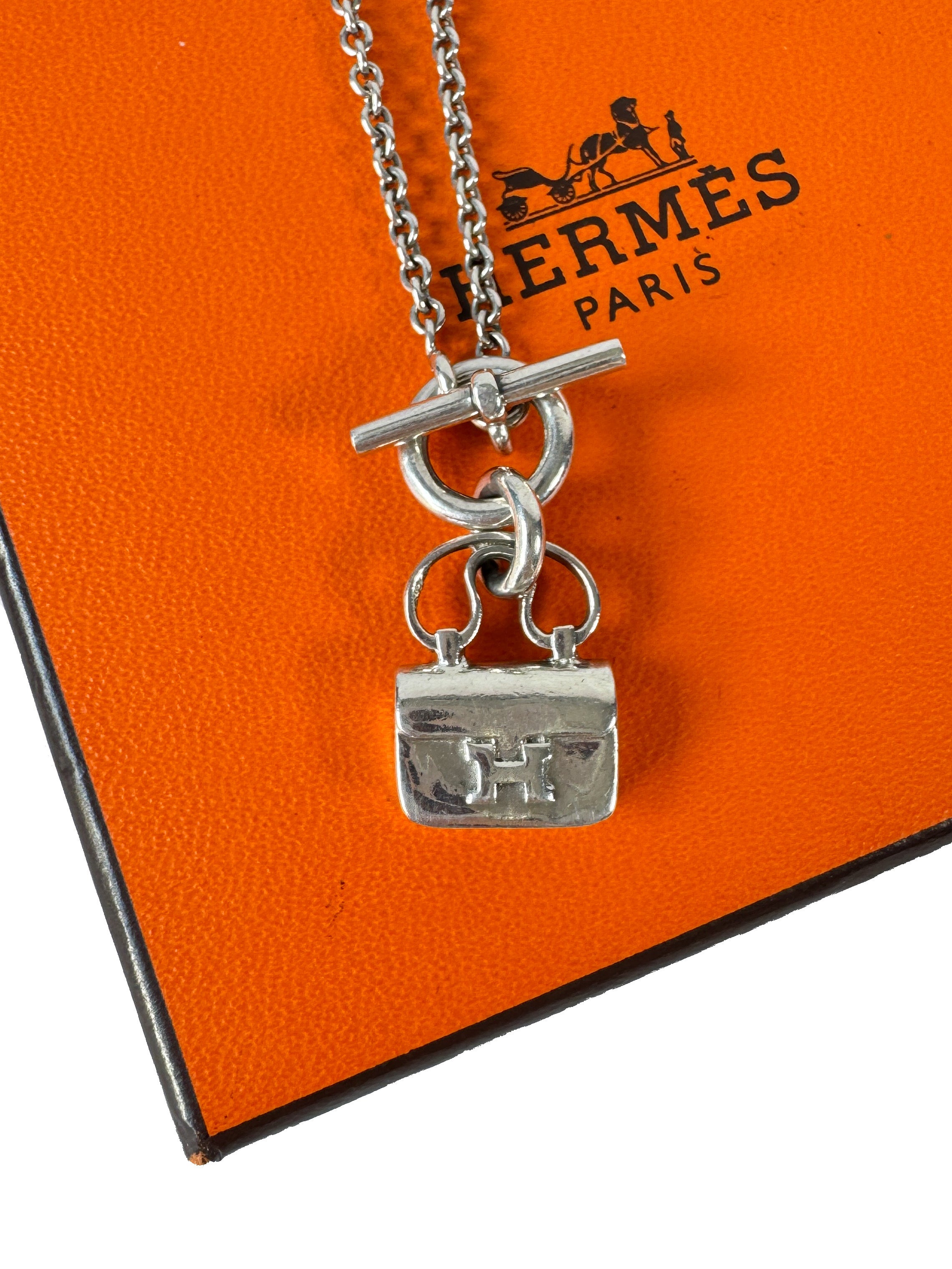 Hermès sterling silver constance amulet necklace retail $980