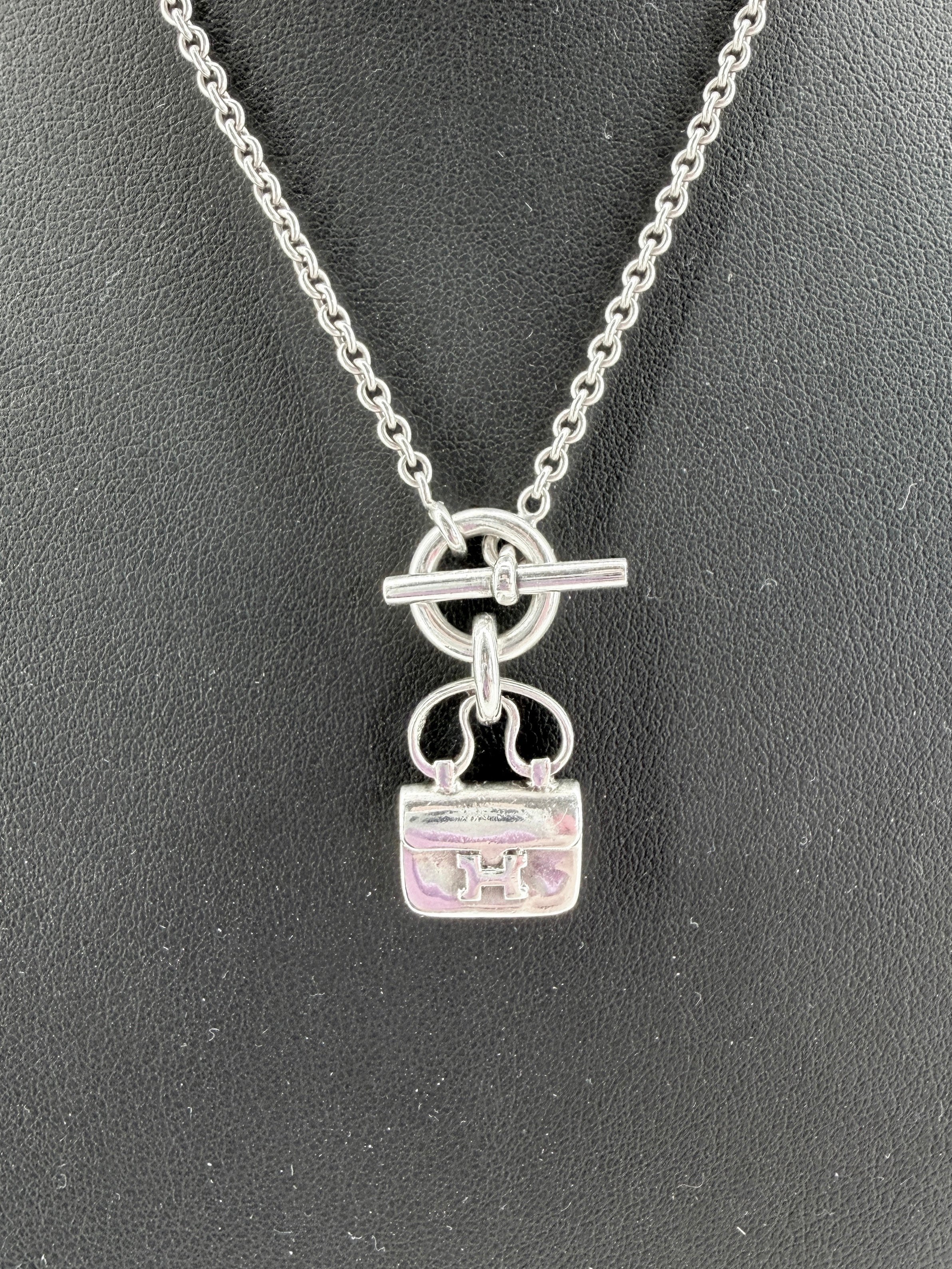 Hermès sterling silver Constance amulet necklace