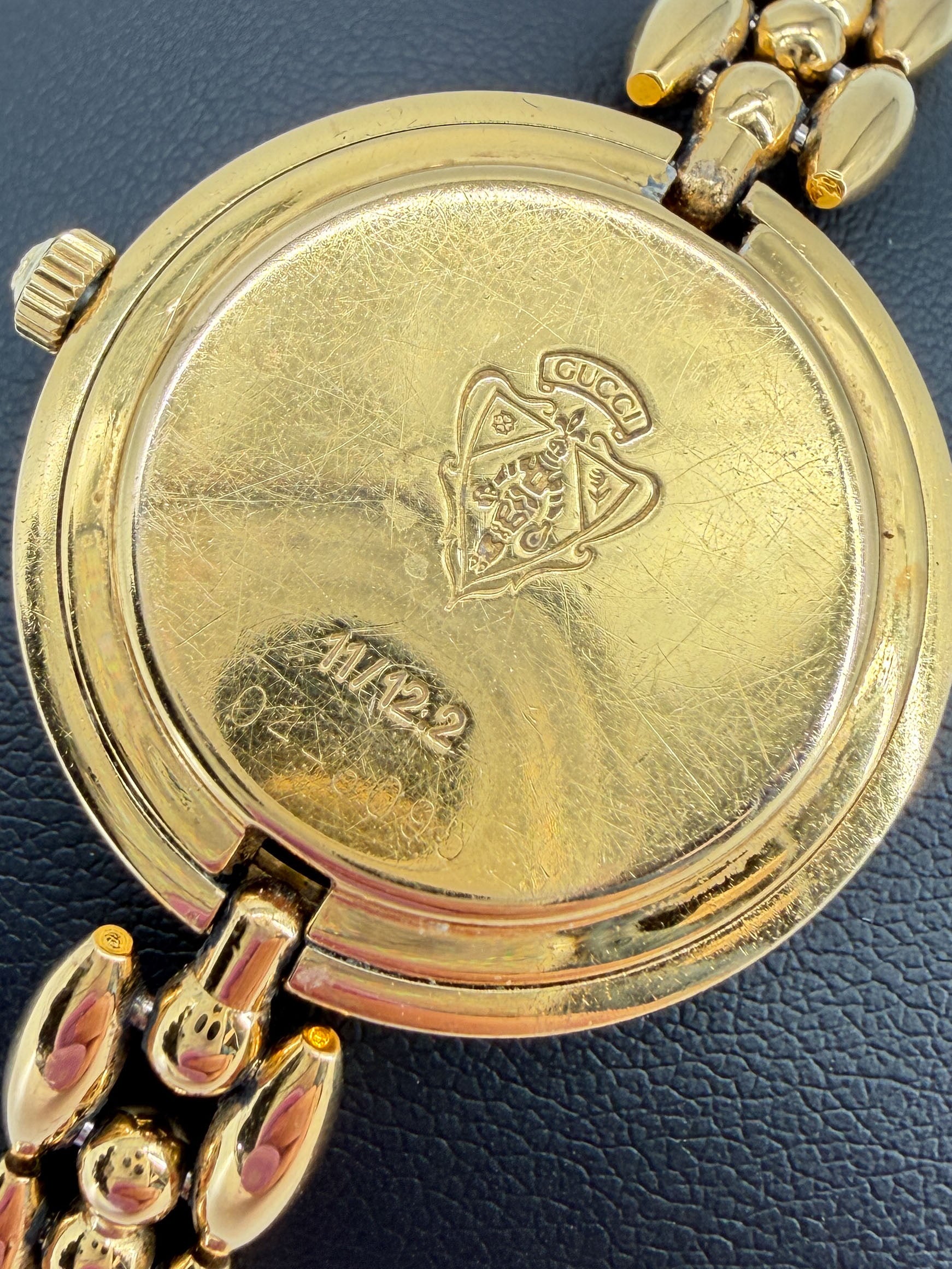 Gucci gold tone bezel watch with plates